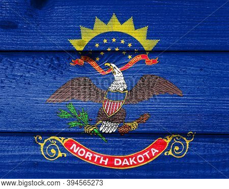 North Dakota Flag Painted On Old Wood Plank Background. Brushed Natural Light Knotted Wooden Board T