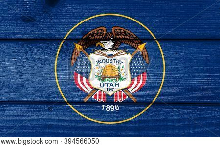Utah Flag Painted On Old Wood Plank Background. Brushed Natural Light Knotted Wooden Board Texture. 
