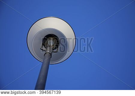 White Street Lamp Seen From Below With Blue Sky