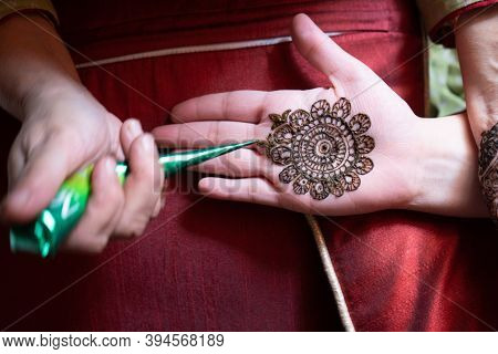 Top Down Video Of A Woman Copying The Mehndi Henna Tattoo From One Hand To The Other In Preparation 