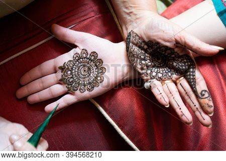 Top Down Video Of A Woman Copying The Mehndi Henna Tattoo From One Hand To The Other In Preparation 
