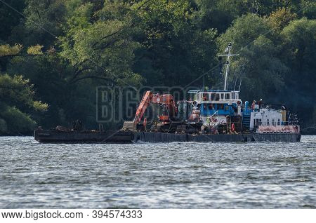Pusher Tug And Barge - A Floating Platform With On Deck Excavator For Hydrotechnical Works On The Wa
