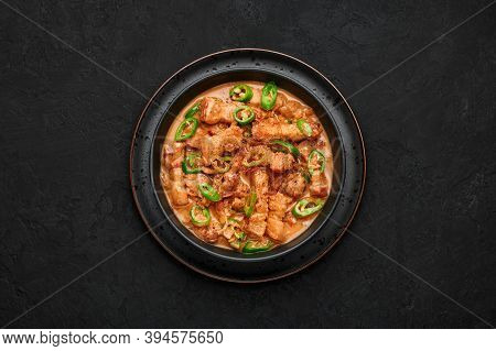 Bicol Express Stew In Black Bowl On Dark Slate Table Top. Filipino Cuisine Spicy Pork Belly Coconut