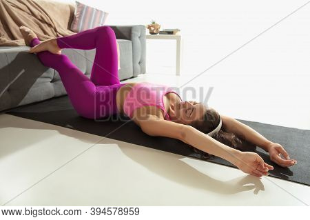 Stretching. Beautiful Young Woman Working Out Indoors, Doing Yoga Exercise On Gray Mat At Home. Unre