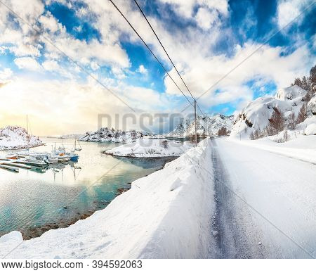 Charming Winter Scenery With Yachts And Boats Nier Pier In Small Fishing Village And Snowy  Mountain