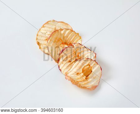 Dried apple slices (apple chips or rings) in a row