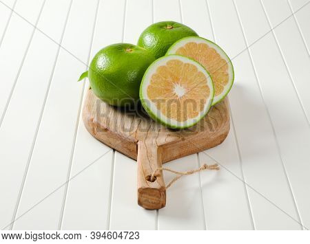 Sweetie fruits (green grapefruits, pomelits) on cutting board