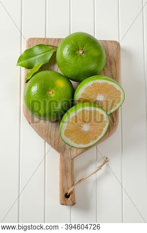 Sweetie fruits (green grapefruits, pomelits) on cutting board