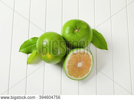 Two and a half sweetie fruits (green grapefruits, pomelits) and leaves