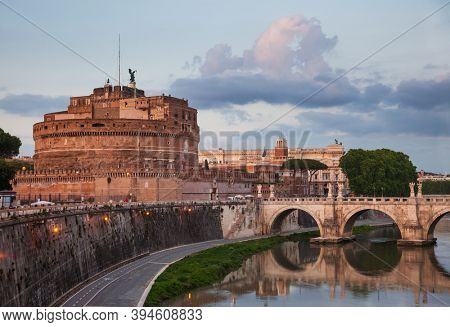 Evening view of Tiber embankment with the Mausoleum of Hadrian or Castel SantAngelo circular 2nd-century castle and Ponte Sant Angelo ancient pedestrian bridge in Rome, Italy