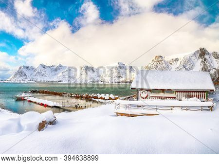 Wonderful Winter Scenery With Wooden Houses In Small Fishing Village And Snowy  Mountain Peaks Near 