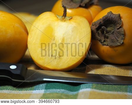 Persimmon Fruits. Half Of The Persimmon. Fresh Fruit. Healthy Lifestyle.