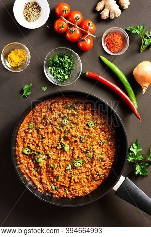 Keema Curry In Frying Pan Over Dark Brown Background. Indian And Pakistani Style Dish. Top View, Fla