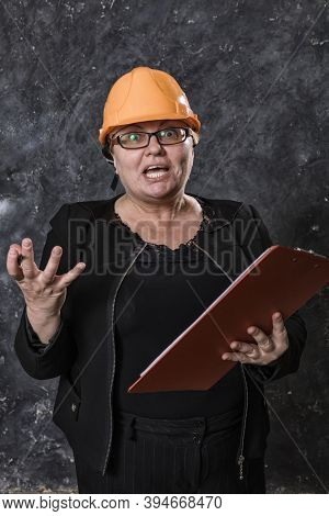 Middle-aged Woman Construction Superintendent In Helmet Studio Portrait.