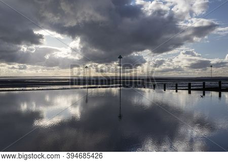 Reflections on Westcliff beach, near Southend-on-Sea, Essex, England