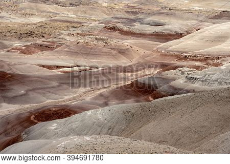 Red And Tan Bentonite Hills Spanning Across Desert Wilderness