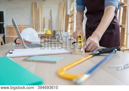 Beautiful Asian Adult Woman Wearing Jeans Clothes Working As A Carpenter In Room At Home. Concept Fo