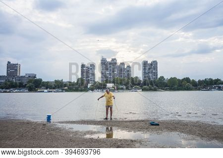Belgrade, Serbia - July 15, 2017: Old Man, Fisherman With Fishing Nets, Standing In Front Of Danube 