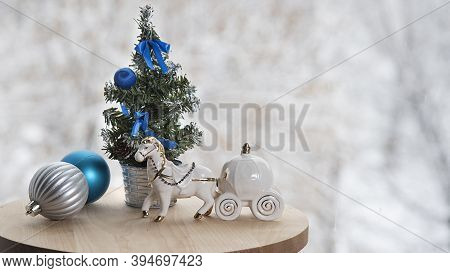 Christmas Banner With  New Year Tree, Dcorations And White Toy Horse On Table Near Window In Cafe, W