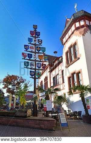 Lorsch, Germany - October 2020: Traditional Guild Pole And Part Of Old Historic City Hall Building I