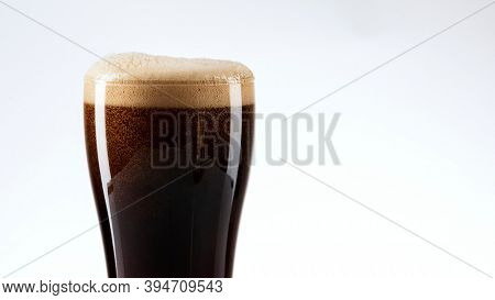 Dark beer with foam closeup