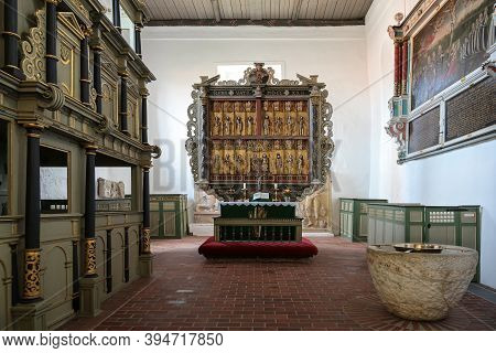 Gudow, Germany, November 13, 2020: St. Mary's Church Chancel With Pews, Baptismal Font And The Medie
