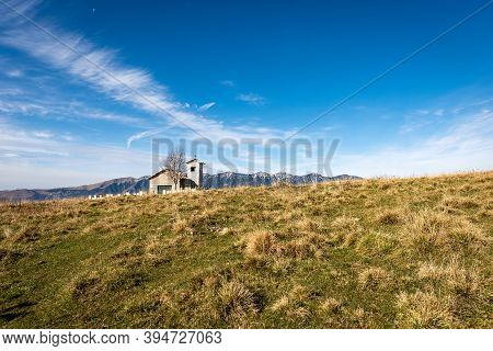 Lessinia Plateau Peak Of Corno D'aquilio And The Monte Baldo (baldo Mountain), With The Small Church