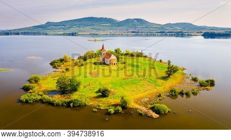 Gothic Church of St. Linhart on island in  Vestonice reservoir. Aerial view to famous landmark on South Moravia, Czech Republic.