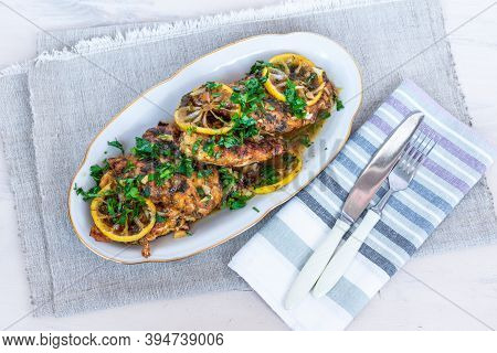 Chicken Francese, Italian-american Dish - Fried Chicken Breast In A Sauce Of Lemon Slices On A White