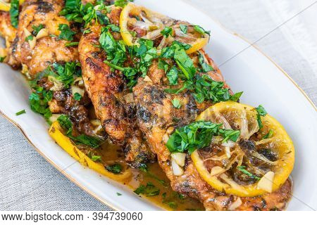Chicken Francese - Fried Chicken Breast With Lemon Slices And Delicious Sauce On A White Plate Close