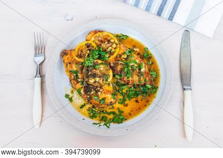 Chicken Francese - Fried Chicken Breast With Lemon Slices And Delicious Sauce On A White Plate On Th