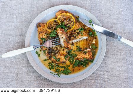 Chicken Francese - Fried Chicken Breast With Lemon Slices And Delicious Sauce On A White Plate On Th