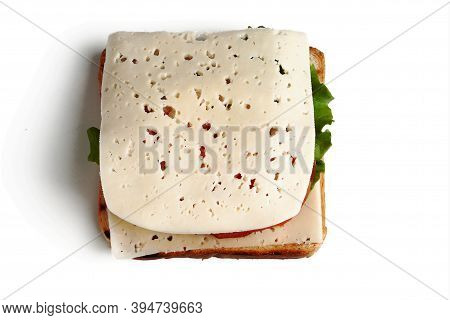 A Slice Of Bread, A Piece Of Cheese, A Lettuce Leaf, Two Pieces Of Smoked Meat, Two Slices Of Cucumb
