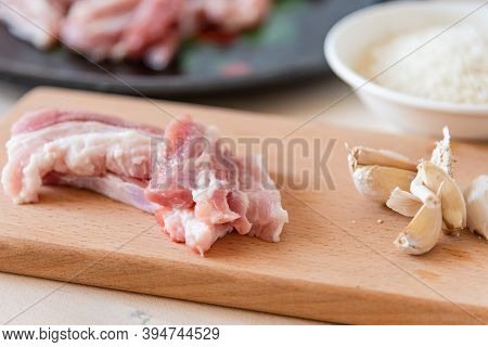 Ingredients For Making Asian Lunch - Raw Pork Belly, Garlic, Onion And Rice