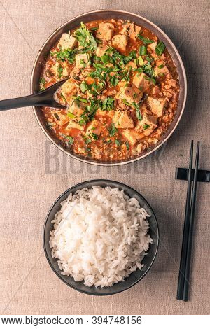 Traditional Chinese Sichuan Cuisine - A Bowl Of Rice And Mapo Tofu In A Large Plate On A Rustic Tabl