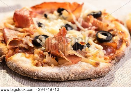 Traditional Italian Appetizer - Mini Pizza, Pizzetta With Jamon On A Linen Napkin Close-up - Roman S