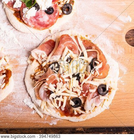 Cooking Traditional Italian Mini Pizza, Pizzetta - Raw Mini Pizza With Tomato Sauce, Black Olives, J