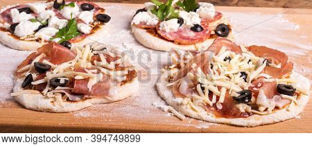 Cooking Traditional Italian Mini Pizza, Pizzetta - Mini Pizza With Tomato Sauce, Salami, Jamon And M