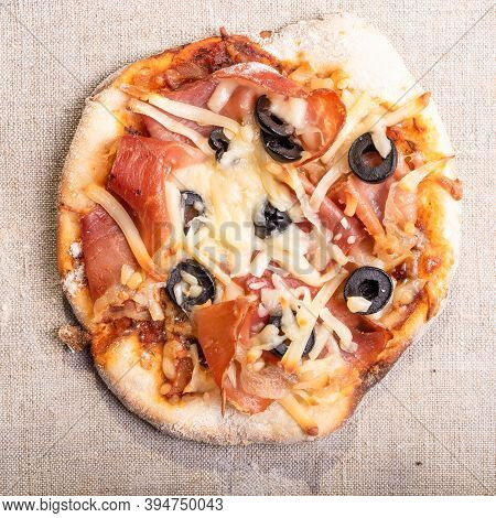Traditional Italian Appetizer - Mini Pizza, Pizzetta With Jamon On A Linen Napkin Close-up - Roman S