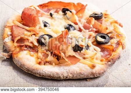 Traditional Italian Appetizer - Mini Pizza, Pizzetta With Jamon On A Linen Napkin Close-up - Roman S
