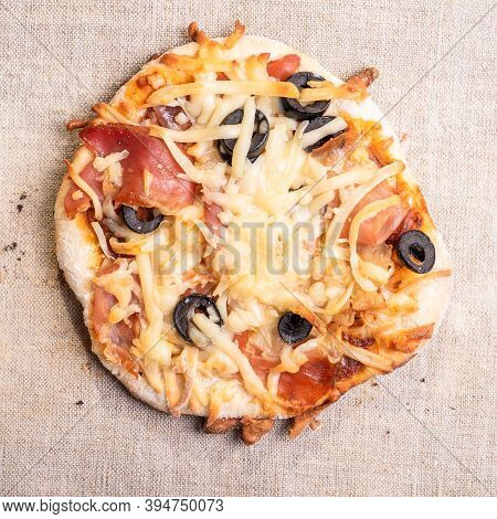 Traditional Italian Appetizer - Mini Pizza, Pizzetta With Jamon On A Linen Napkin Close-up - Roman S