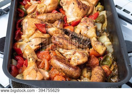 Chicken Scarpariello Close-up In A Baking Sheet - Chicken With Sausages, Peppers, Onions And Pomiodo