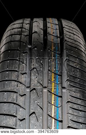 Seasonal Re-shoe Of Car Tires, Summer Wheel With A View Of The Tread On A Dark Background Front View