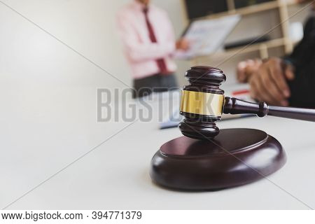 Wooden Gavel On Table In Lawyer's Office. Lawyer Having Team Meeting With The Client. Concepts Of La