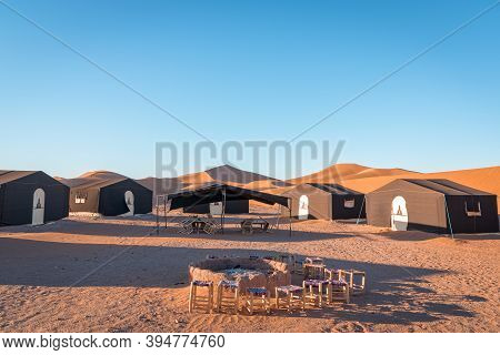 Desert Camp And Campfire In Dunes Of Erg Chigaga, At The Gates Of The Sahara. Morocco. Concept Of Tr