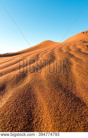 Daytime Close-up Desert Dunes Of Erg Chigaga, At Sahara. Morocco. Concept Of Travel And Adventure.