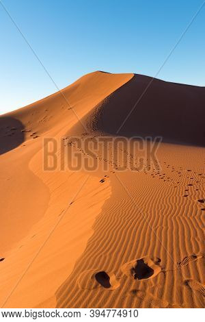 Wide Angle Shoot Of Footpath In Desert Dunes Of Erg Chigaga.the Gates Of The Sahara, At Sunrise. Mor