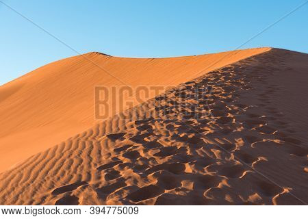 Wide Angle Shoot Of Footpath In Desert Dunes Of Erg Chigaga.the Gates Of The Sahara, At Sunrise. Mor