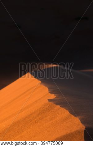 Close-up Of Sand Desert Dunes Of Erg Chigaga Moved By The Wind. Sahara, At Sunrise. Morocco. Concept