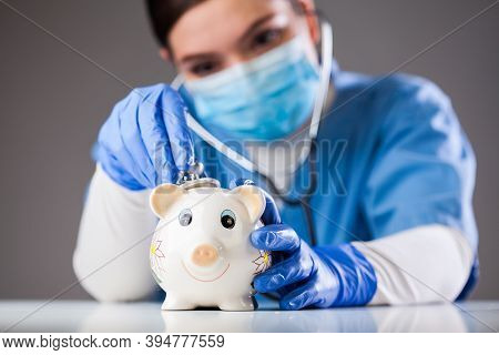Doctor Inspecting Piggy Bank With Stethoscope, Economy Recession Due To Global Covid-19 Coronavirus 
